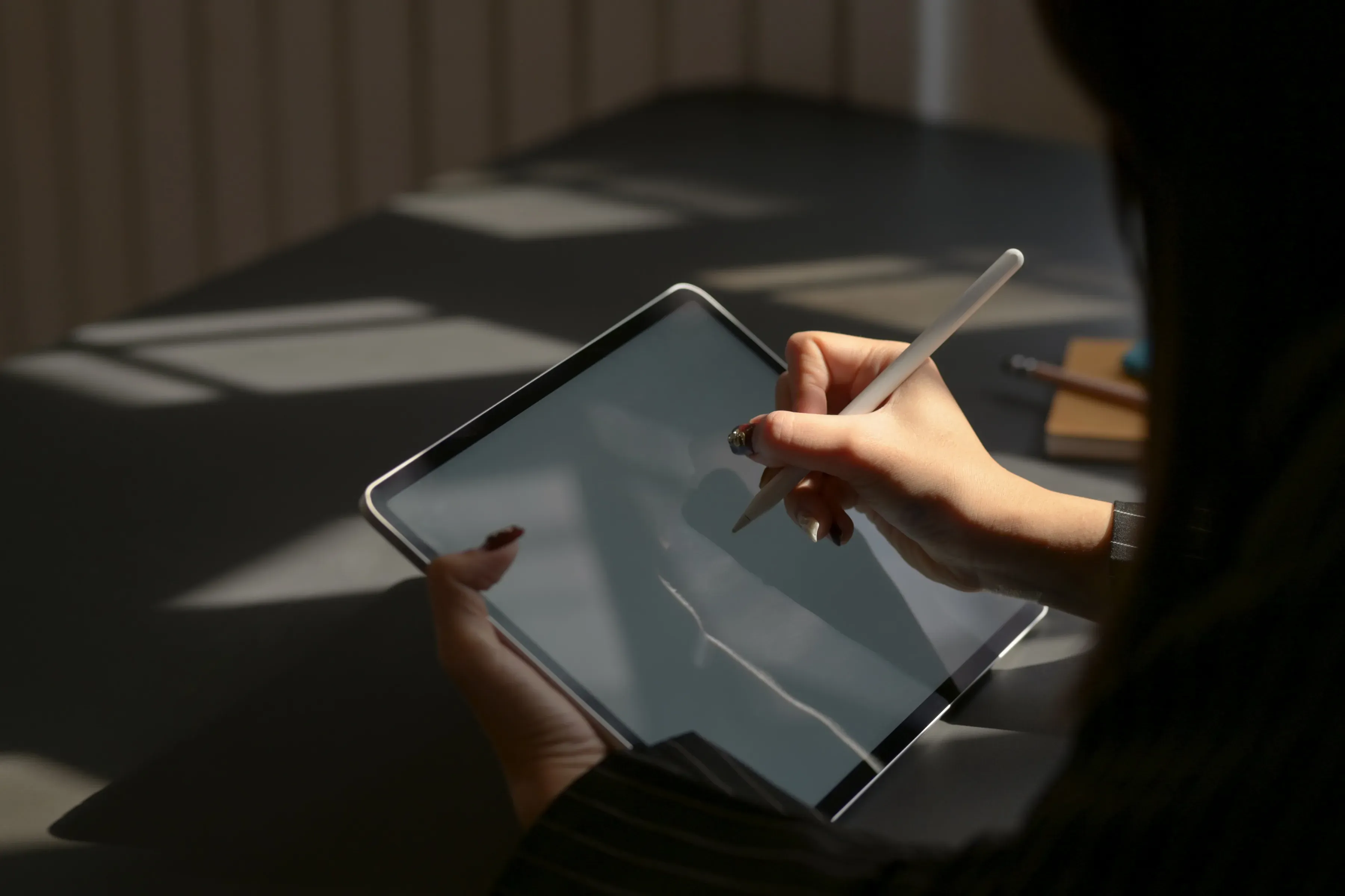 A test creator working on a tablet with a stylus.