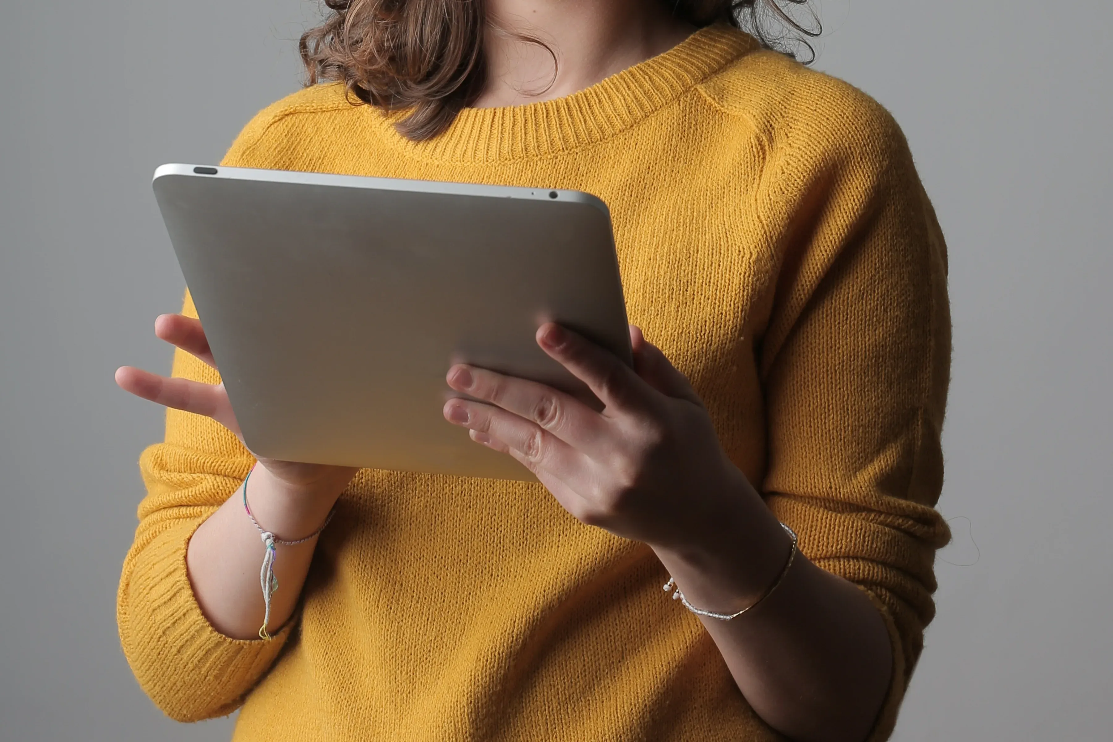 A test publisher reviewing materials on a tablet.